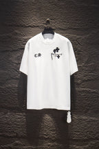 White short-sleeve T-shirt with black cross and monogram graphic on chest.