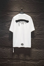 White short-sleeve T-shirt, back graphic text bar with small circular emblem.