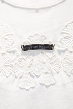 Beaded horizontal bar detail with dark metal on white embroidered fabric