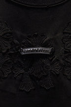 Black embroidered chest panel with a silver-tone horizontal crest detail