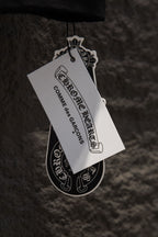 Hanging product tag attached to a black garment