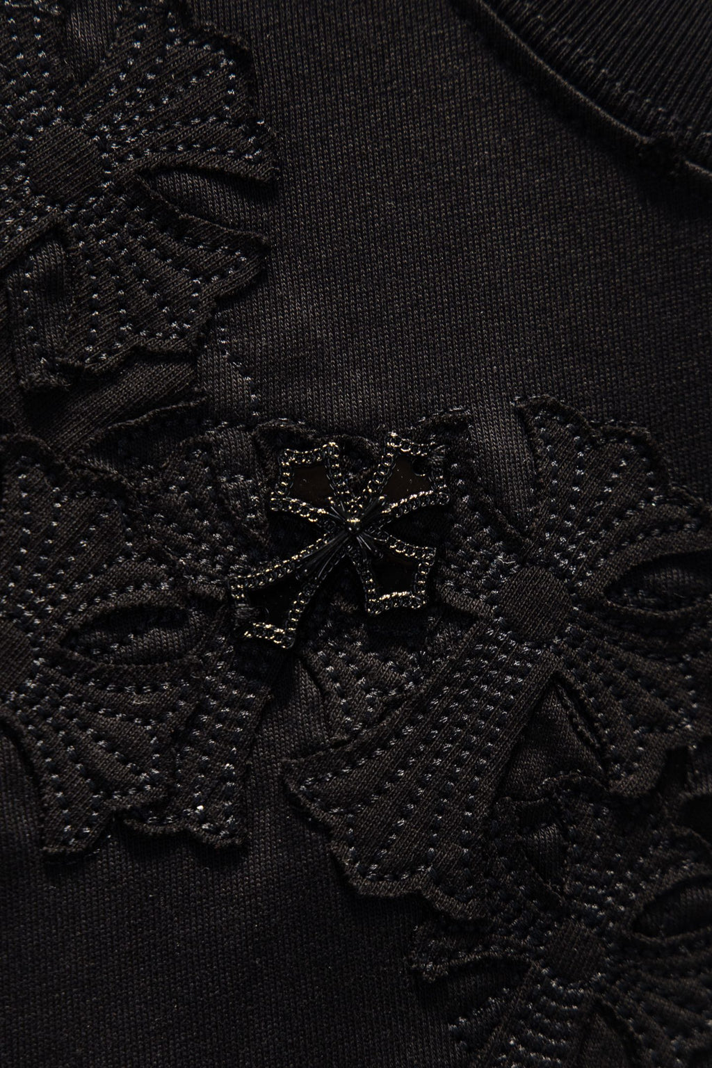 Black embroidered fabric texture with dense raised floral stitching
