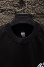 Black T-shirt neckline with ribbed collar and overlock stitching