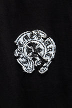 Black T-shirt with detailed white embroidered-style graphic logo on the chest