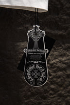 White T-shirt on hanger with black and white clothing tag