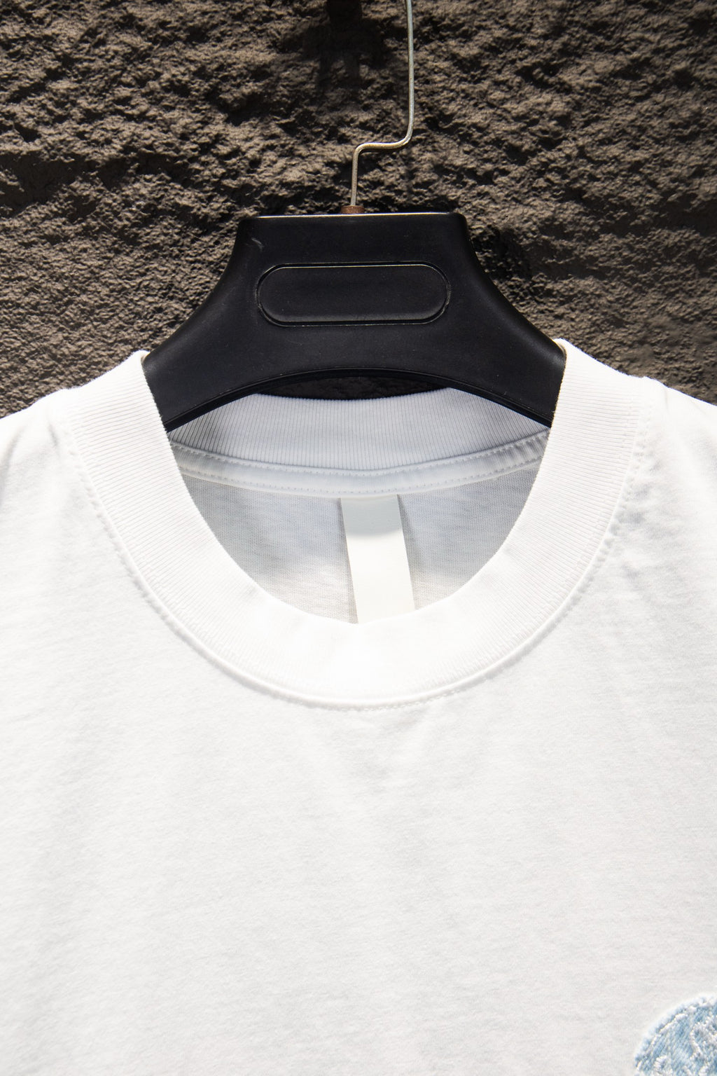 White T-shirt crew neck with partial light blue embroidered graphic detail
