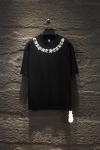 Black short-sleeve T-shirt with white logo graphic across chest, on hanger