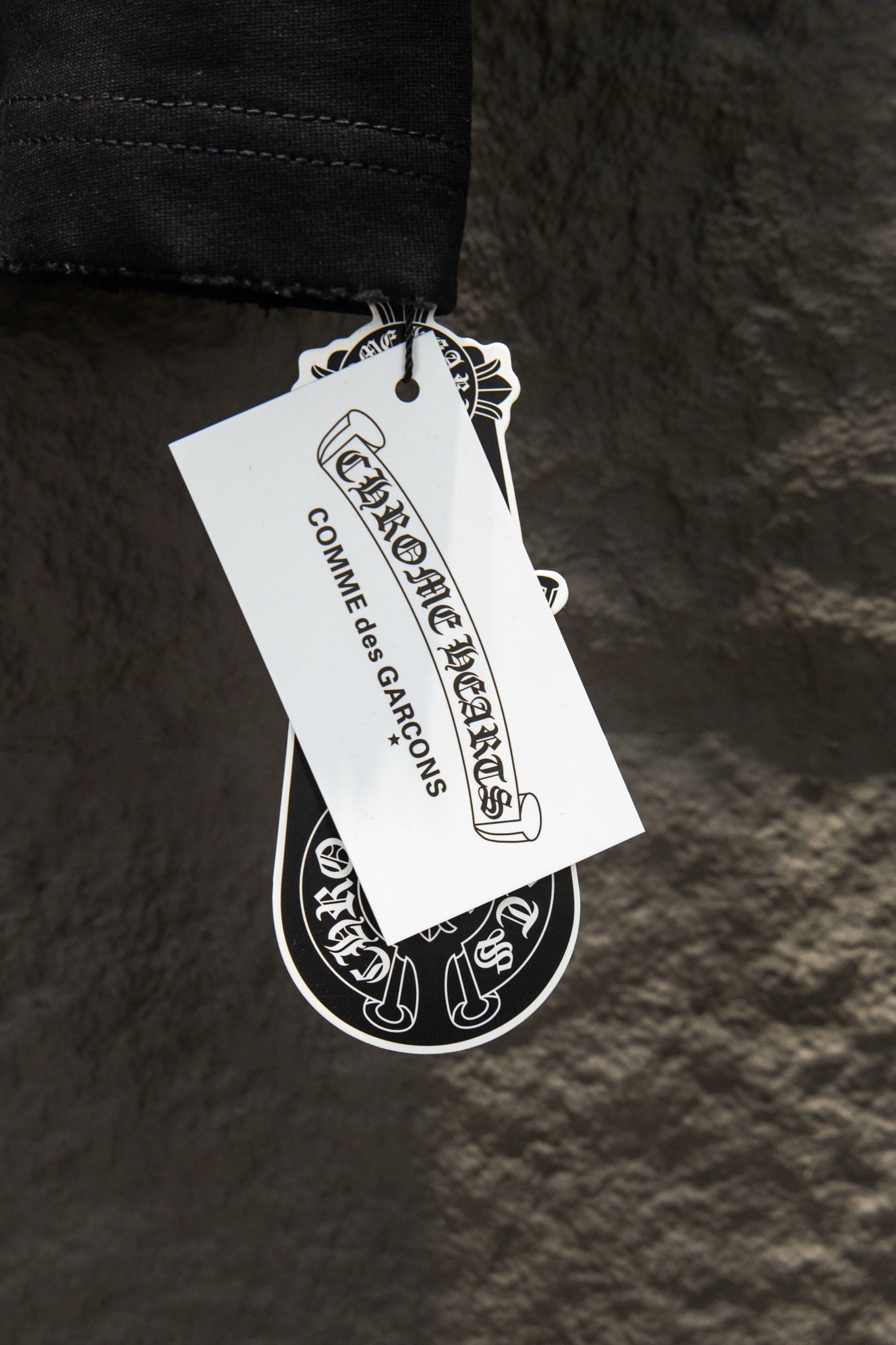 Black T-shirt with hanging brand tag and printed label