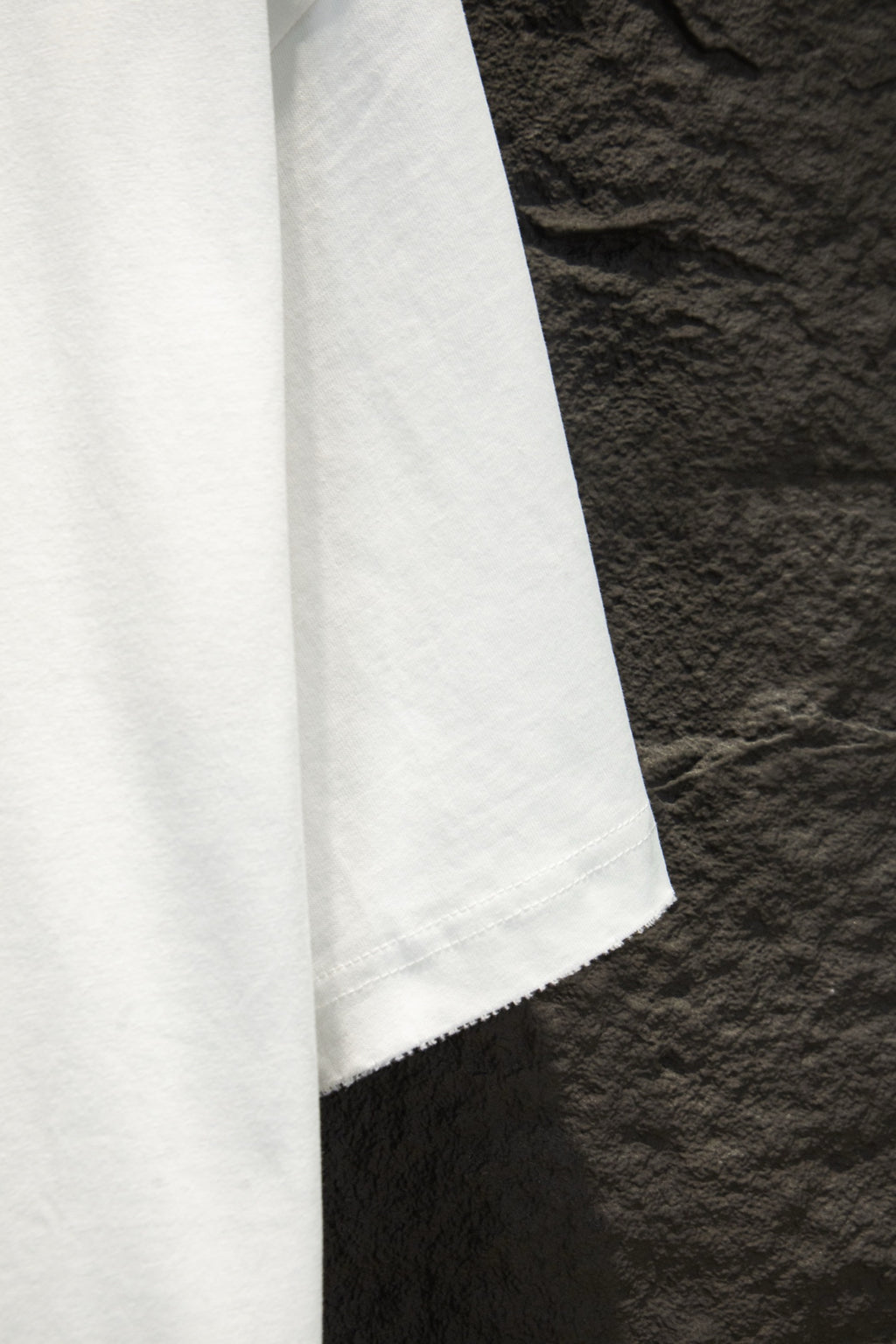 White T-shirt side view with hem and visible seam stitching