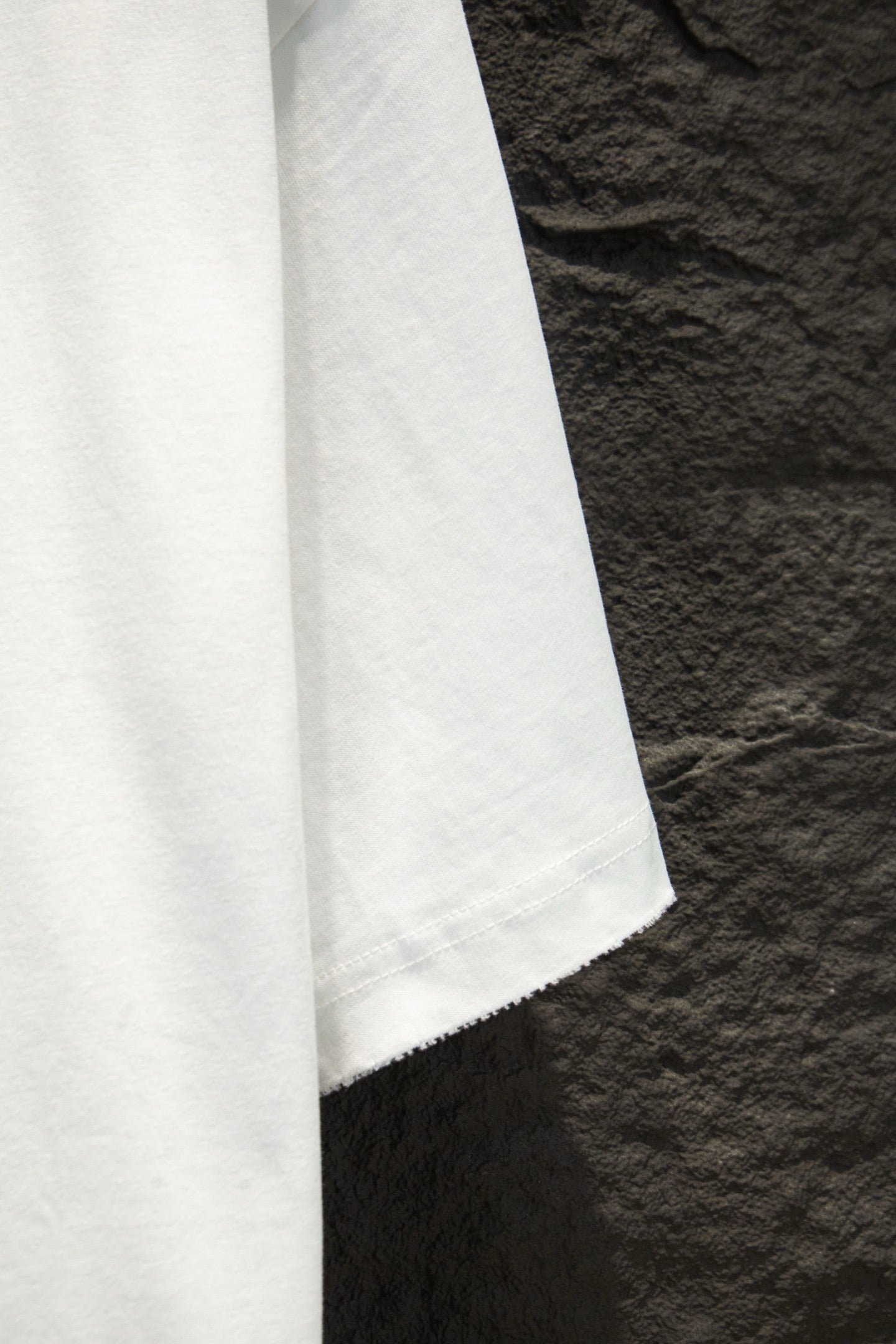 White T-shirt side view with hem and visible seam stitching