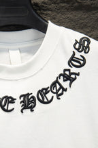 White T-shirt with black embroidered logo on sleeve/shoulder