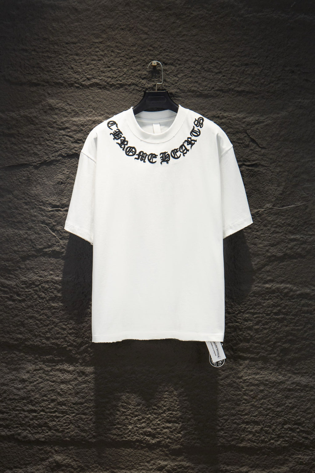White short-sleeve T-shirt with black graphic logo across chest