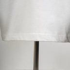 White T-shirt with neat stitching at hem and side seam.
