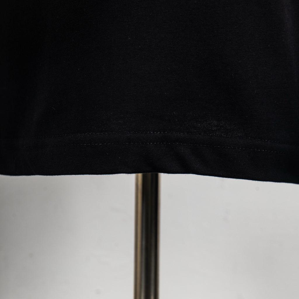Black T-shirt hem with visible stitching