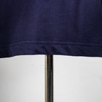 Bottom hem close-up on dark navy short-sleeve T-shirt with neat stitching