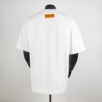 T-shirt back view in white with orange brand label at neck