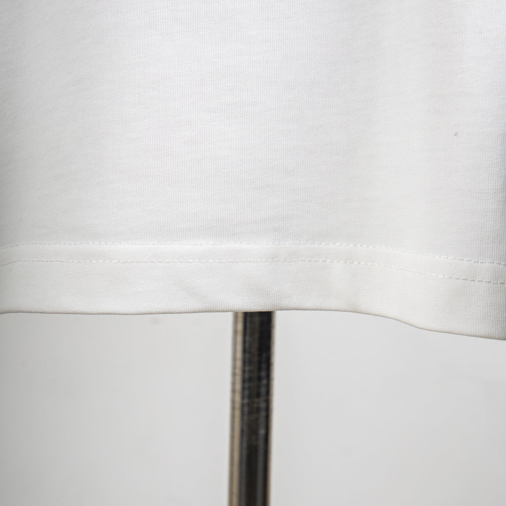 White T-shirt fabric texture and side seam stitching close-up