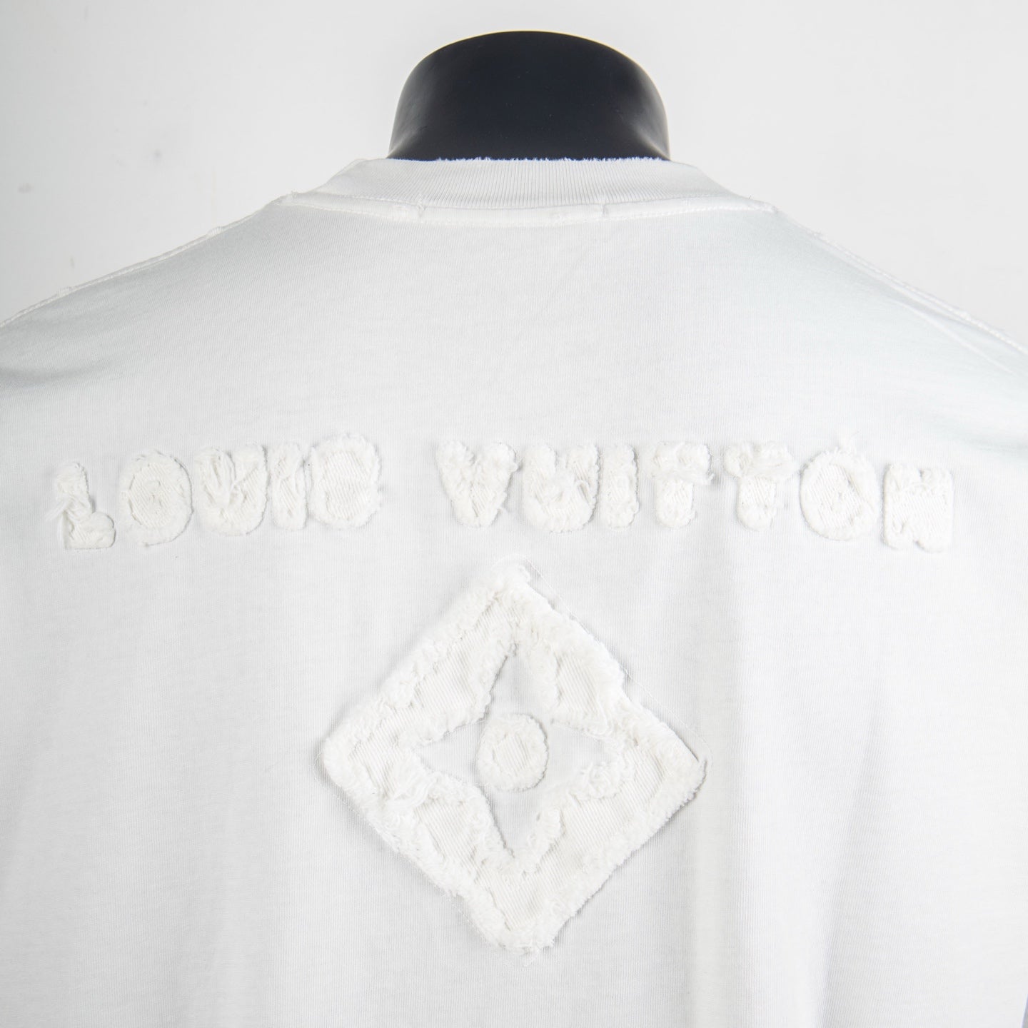 White T-shirt back with raised diamond logo and embossed text detail