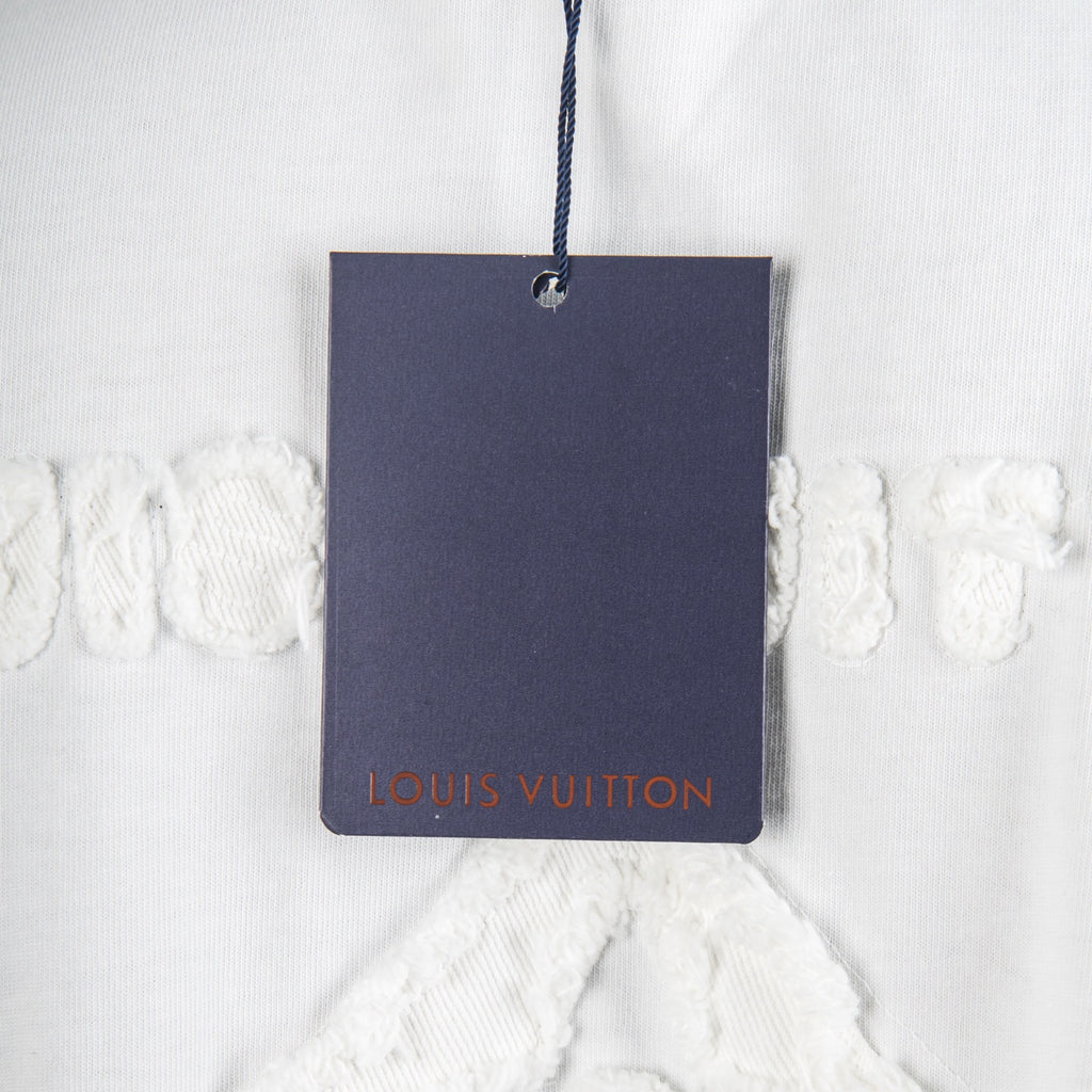 White T-shirt with navy hang tag showing Louis Vuitton logo