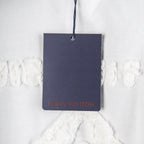 White T-shirt with navy hang tag showing Louis Vuitton logo