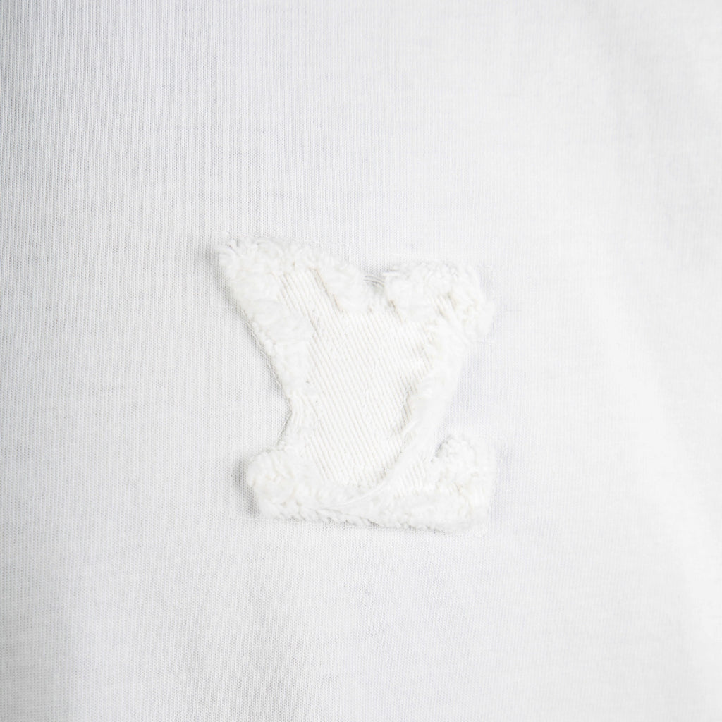 White T-shirt close-up with embroidered chest logo