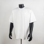 White short-sleeve T-shirt on mannequin with small chest logo patch