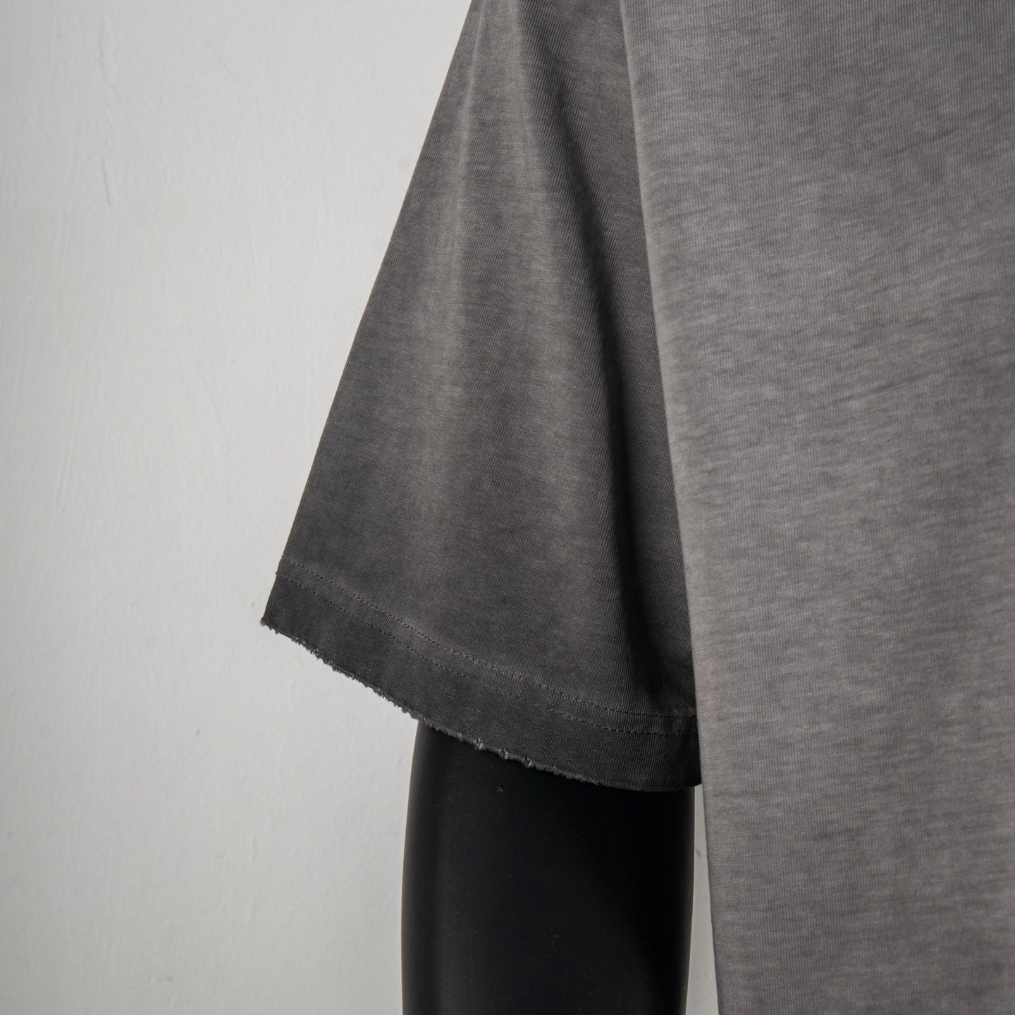 Gray T-shirt sleeve and hem with side drape