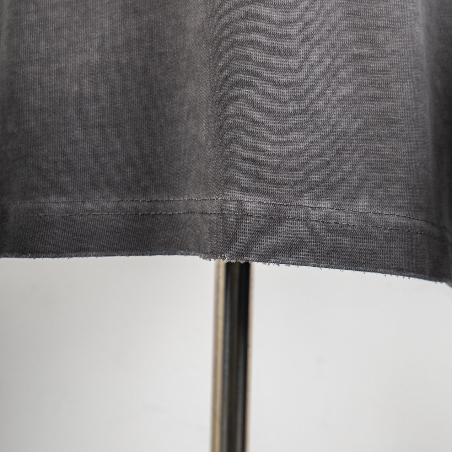 Gray T-shirt hem with stitched seam