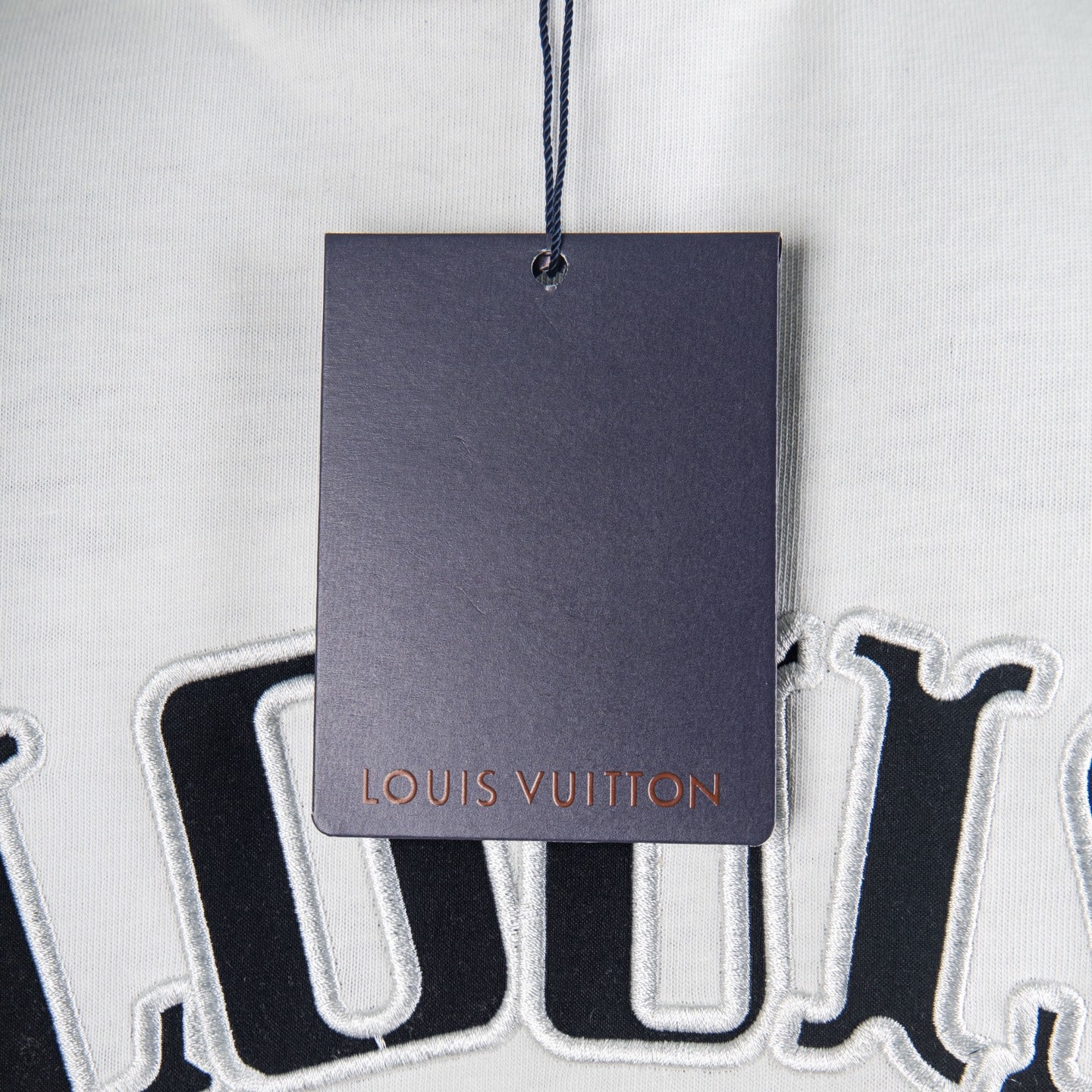 Clothing price tag hanging near a printed T-shirt design
