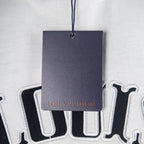 Louis Vuitton garment tag on white T-shirt with string
