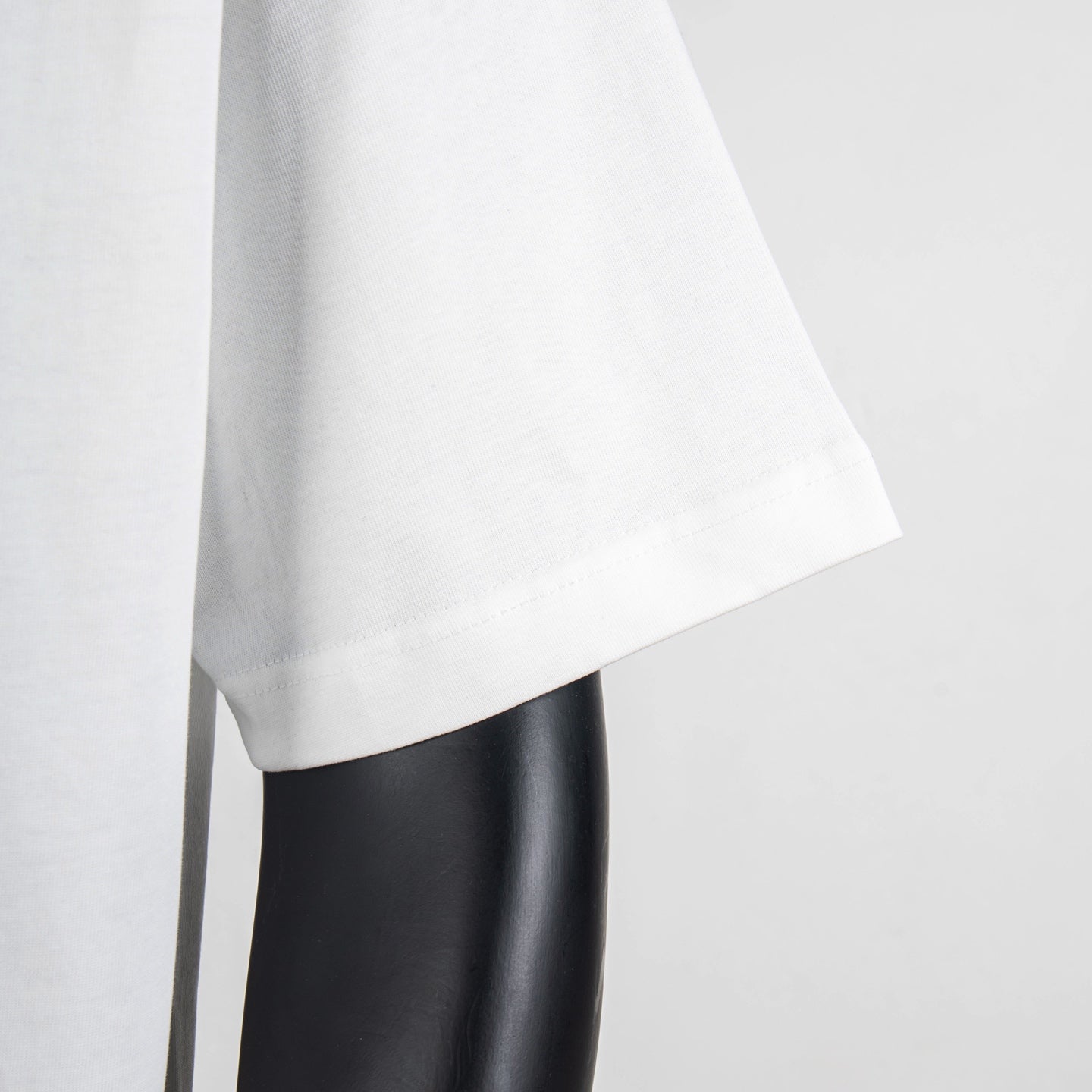 White T-shirt sleeve and side hem close-up