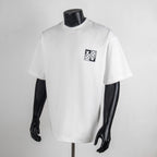 White short-sleeve T-shirt with small square logo patch on the chest