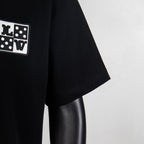 Black short-sleeve T-shirt sleeve detail with logo patch