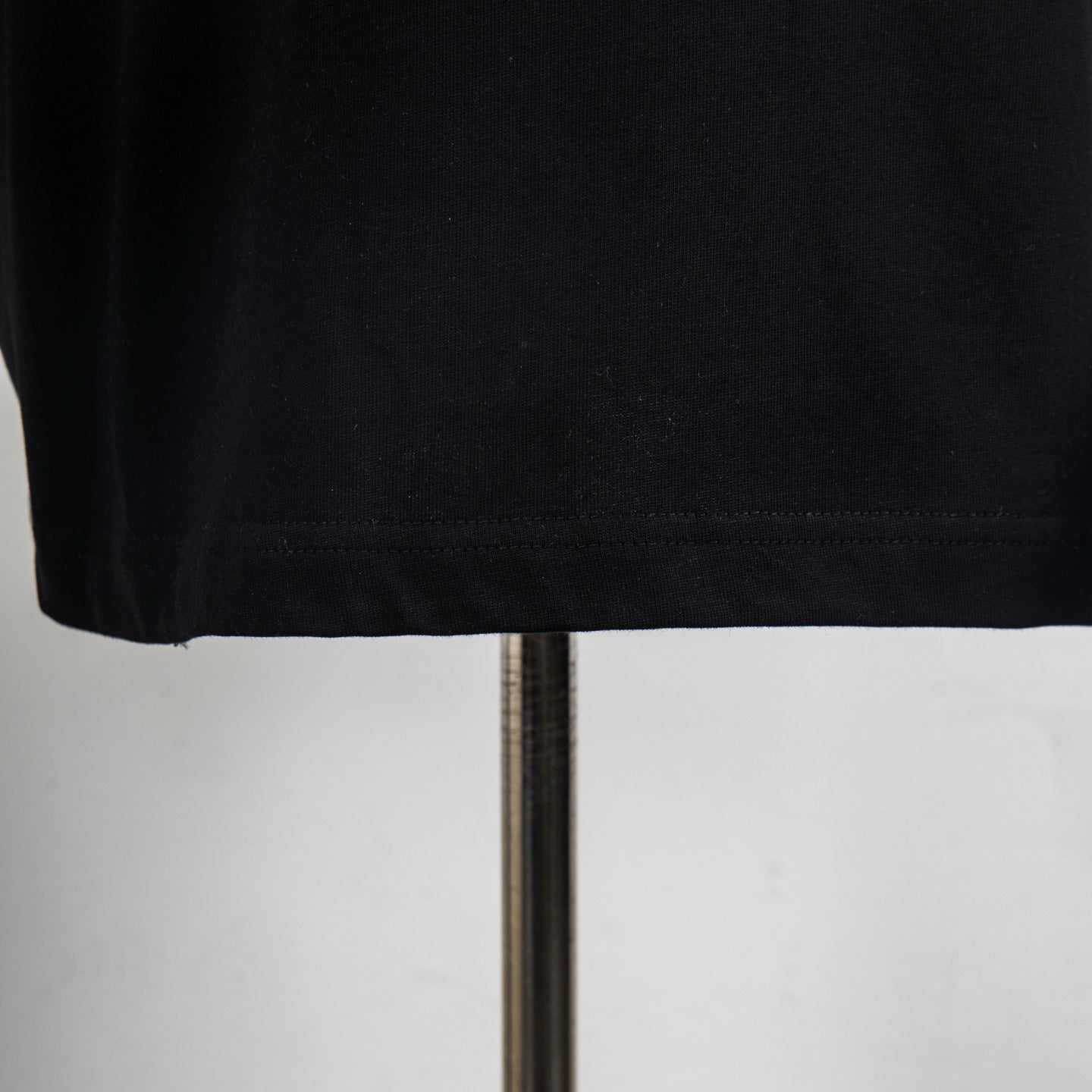 Black T-shirt hem and stitching detail