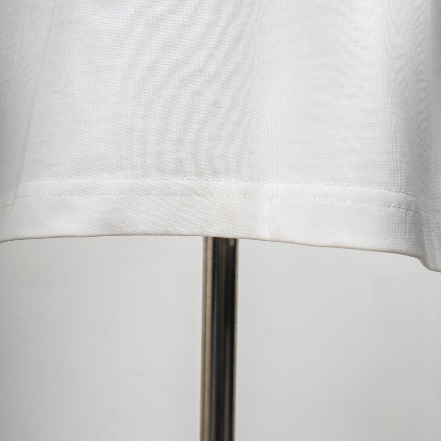 White T-shirt hem seam with reinforced stitching
