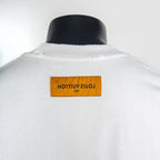 White T-shirt back neck label with yellow tag and logo text