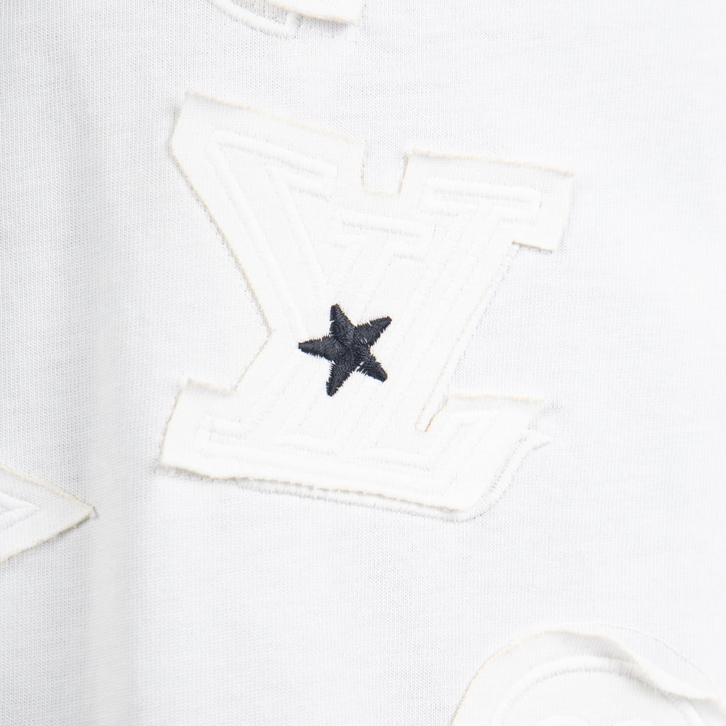 White T-shirt close-up of black star appliqué patch on the front