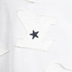 White T-shirt close-up of black star appliqué patch on the front