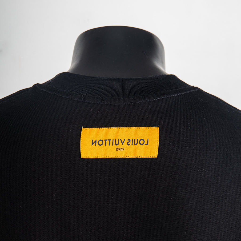 Black T-shirt with yellow neck label reading Louis Vuitton