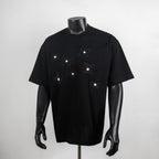 Black crewneck T-shirt with embroidered flower and star graphics