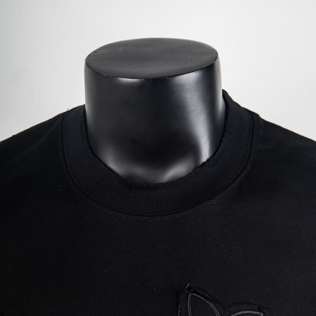 Black crewneck T-shirt neckline detail on mannequin