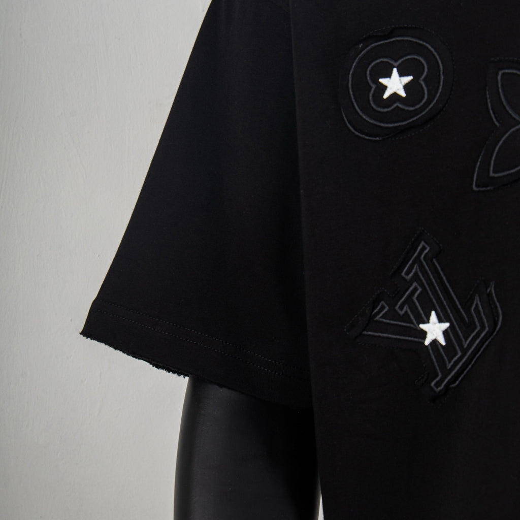 Black T-shirt side with raised circle star and LV-style print