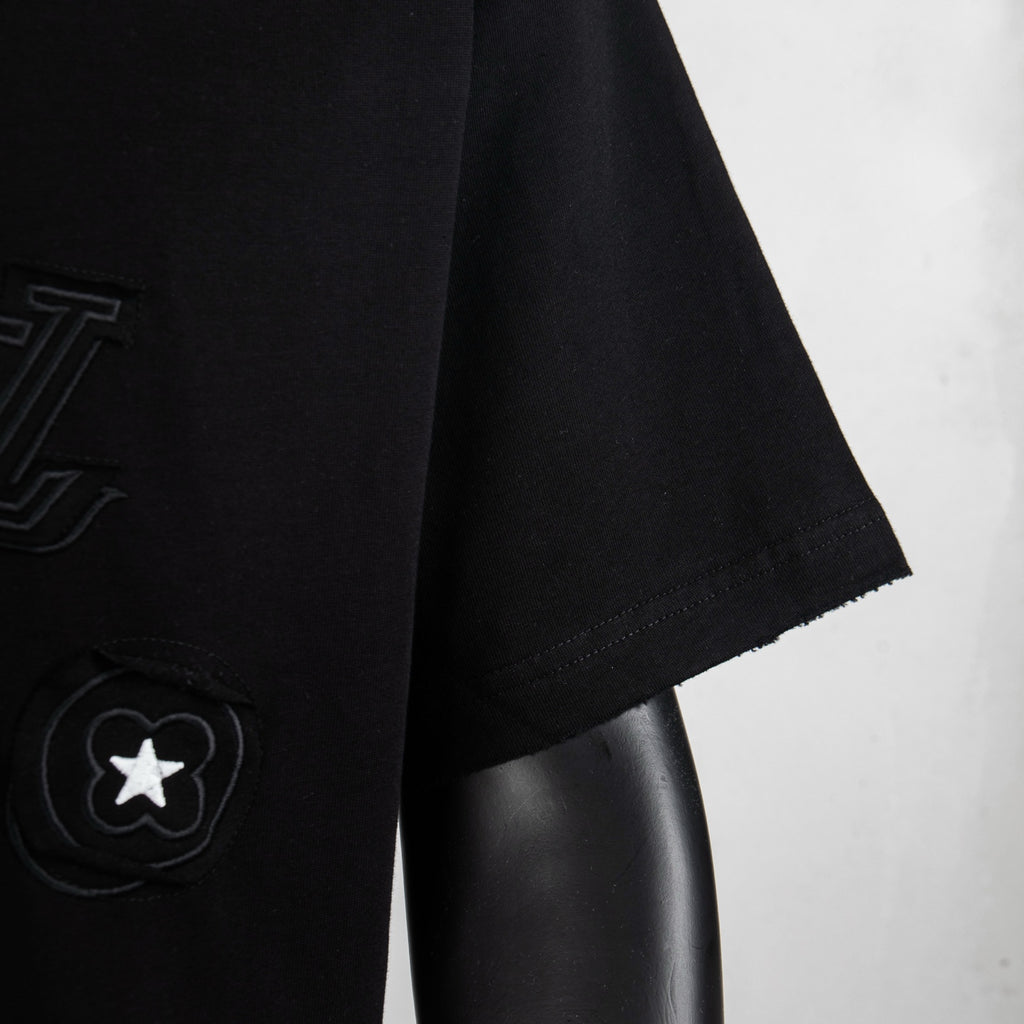 Black T-shirt sleeve and side logo patch with star icon detail
