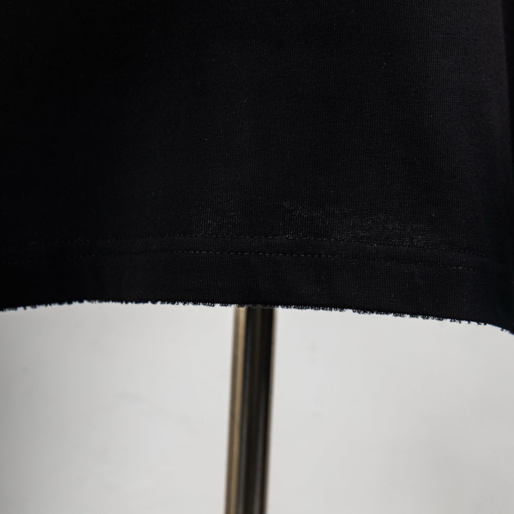 Black T-shirt hem and stitching close-up