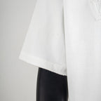White T-shirt hem with clean stitching at the side