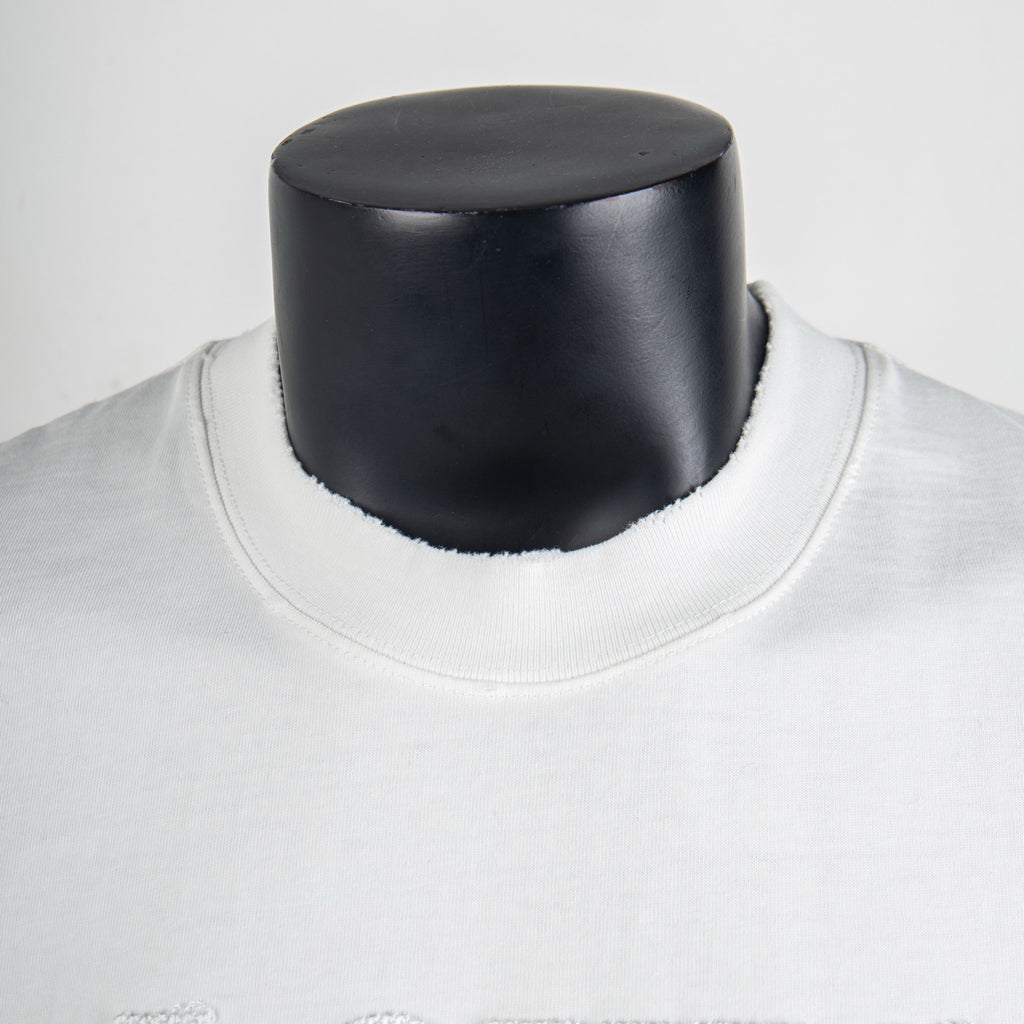 White crewneck T-shirt neckline close-up with ribbed collar