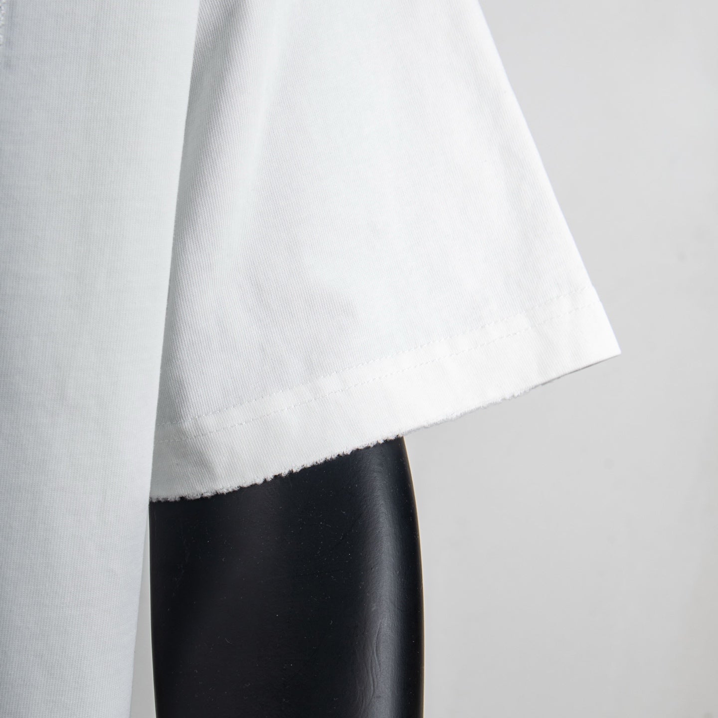 White T-shirt side view with short sleeve cuff and straight hem