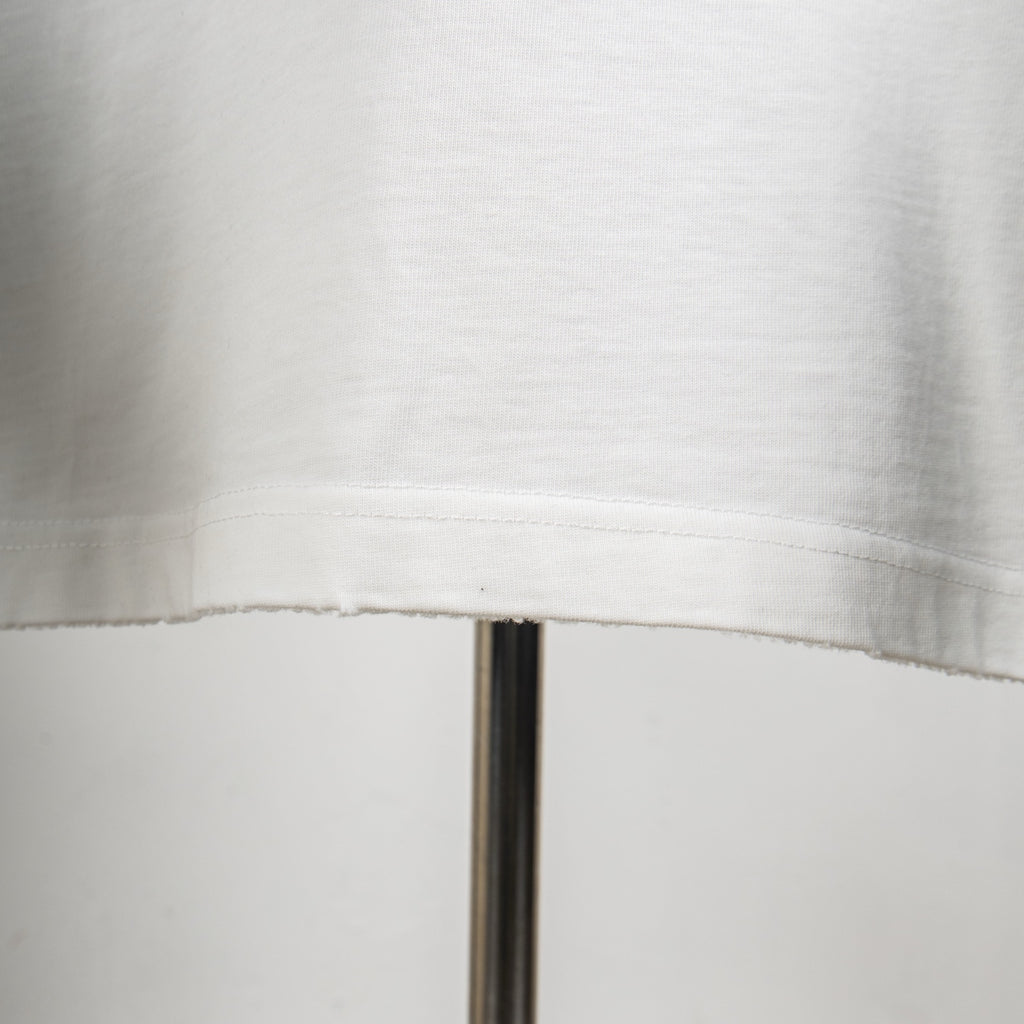 White T-shirt lower hem with visible stitching