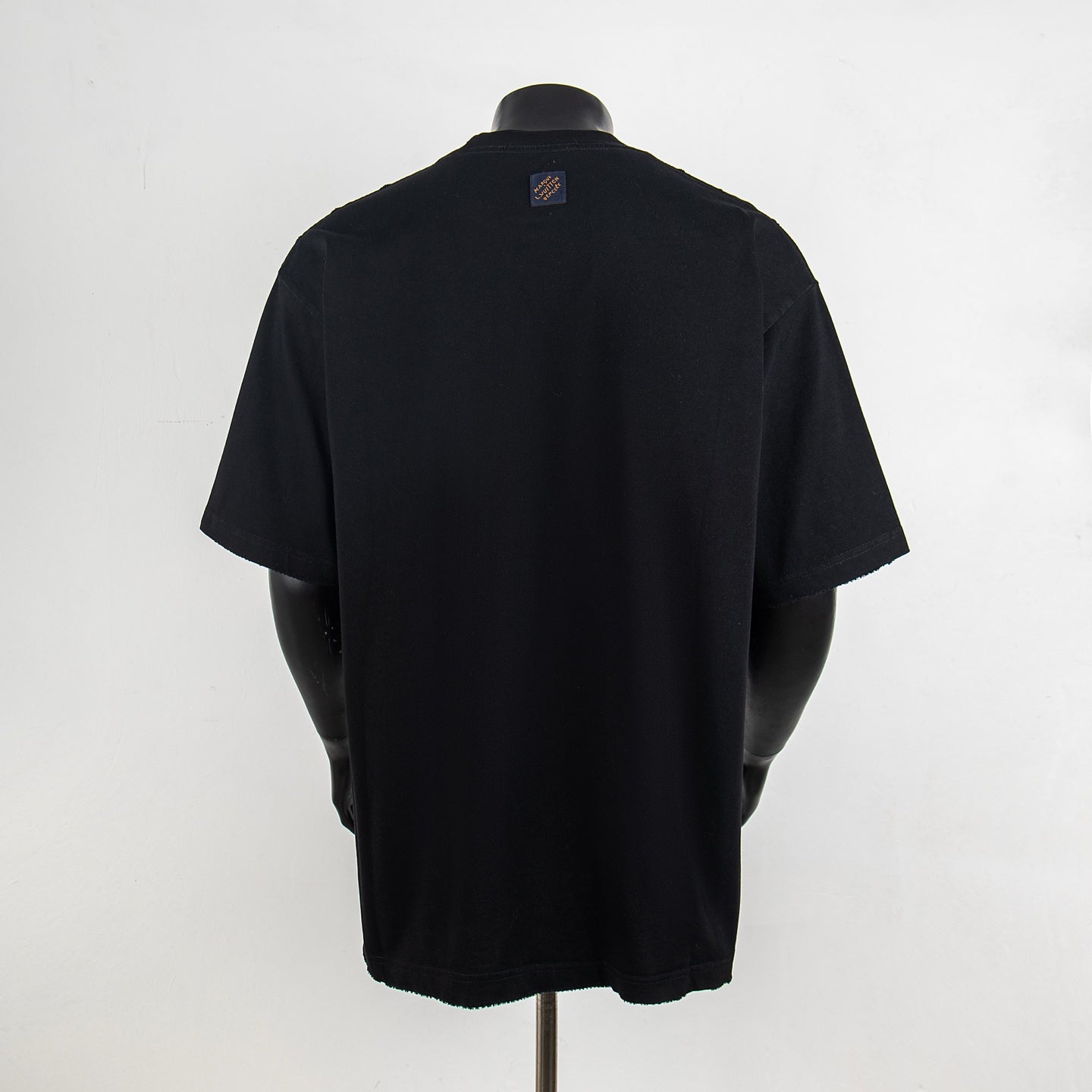 Black short-sleeve T-shirt with small Louis Vuitton logo patch on upper back