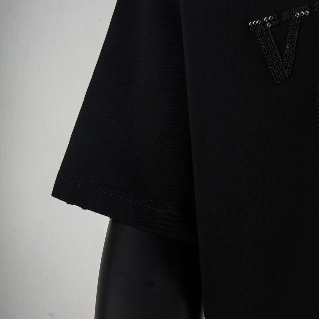 Black short-sleeve T-shirt side view with stitched hem